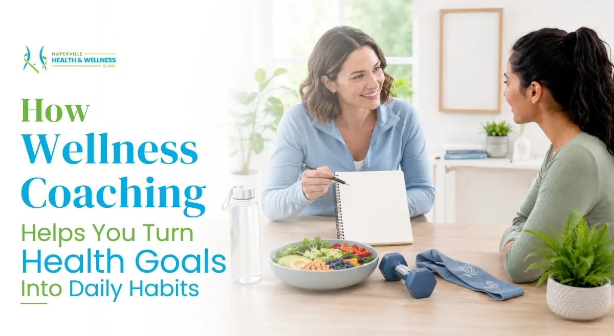 A wellness coach at Naperville Health & Wellness Clinic smiles while presenting a notebook to a client at a wooden table featuring a healthy salad bowl, a dumbbell, a resistance band, and a water bottle. Text on the left reads: "How Wellness Coaching Helps You Turn Health Goals Into Daily Habits